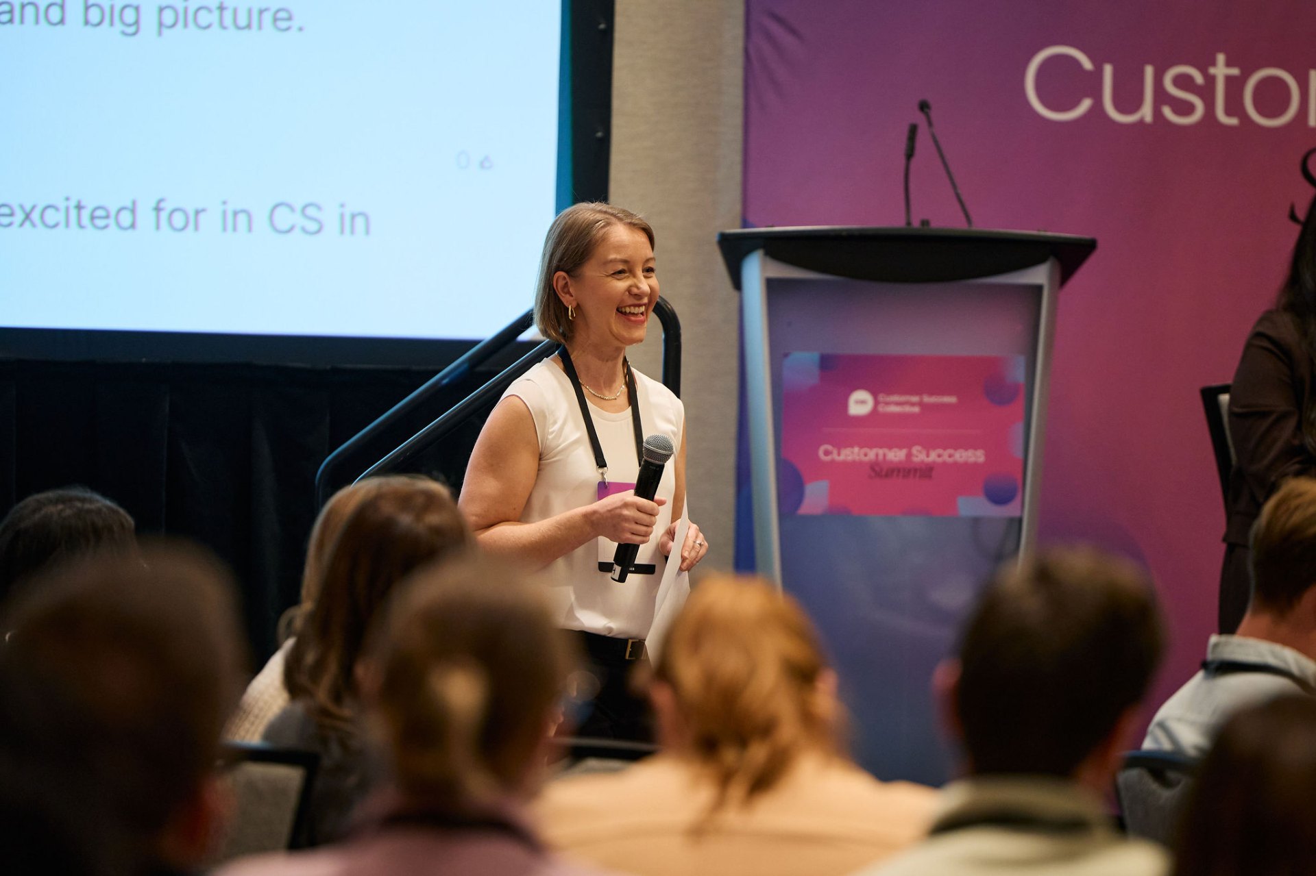 Andrea Bumstead speaking on stage at the Customer Success Summit